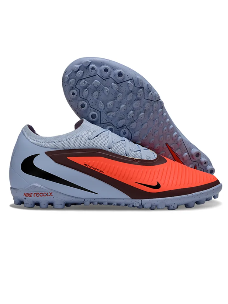 Nike Phantom GX Pro TF (em tom cinza-claro/cinza-azulado e laranja vibrante com detalhes em preto e sola para relva sintética/turf no mesmo tom de cinza).